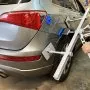 VEVOR dent pull lever bar kit in use on a silver suv rear panel.