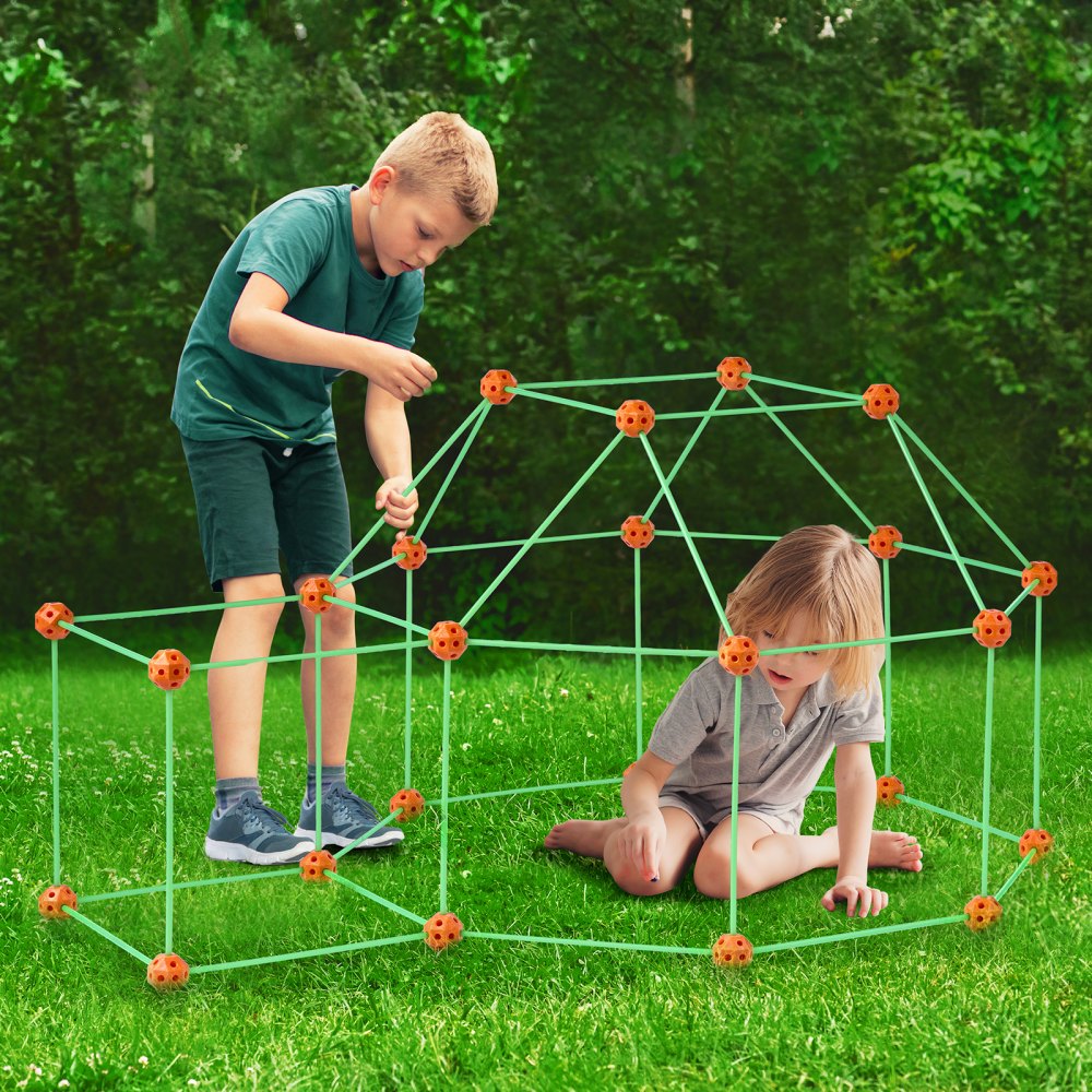 kids building a fun structure on grass using VEVOR tent fort kit, surrounded by greenery.