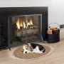 cozy living room with VEVOR fireplace screen, crackling fire, dog resting on a rug, and wood holder.