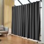 VEVOR room divider with black curtains in a modern living space with wooden flooring and a sofa.