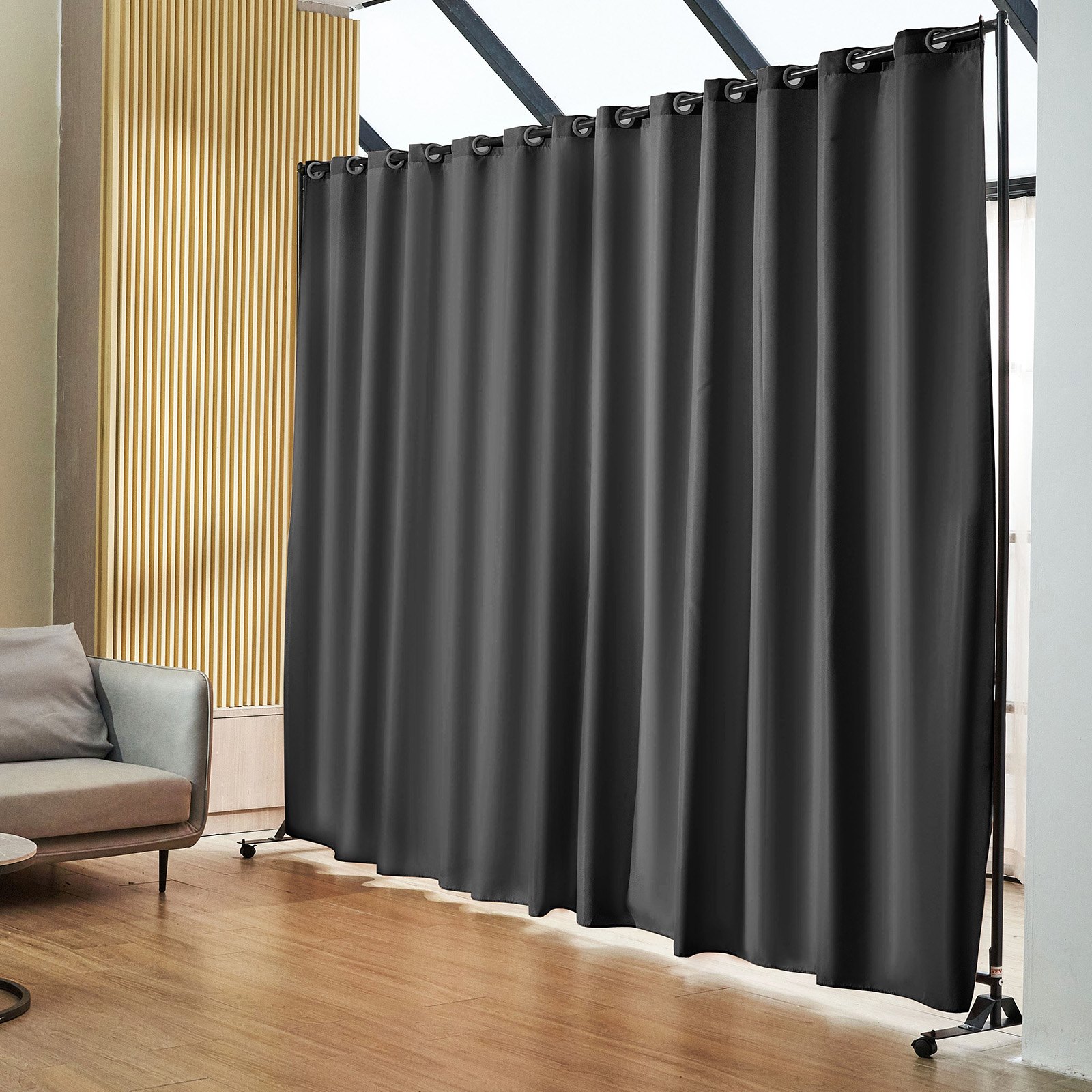 VEVOR room divider with black curtains in a modern living space with wooden flooring and a sofa.