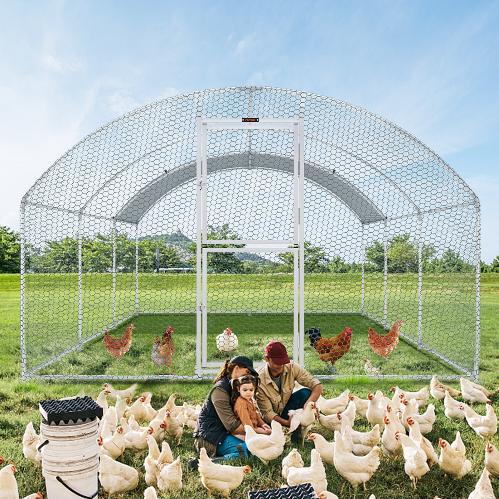 VEVOR large metal chicken coop in a field with chickens and two people tending to white hens outside.