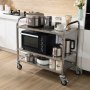 VEVOR kitchen utility cart with kitchen appliances including microwave, rice cooker, and jars on a wood floor.