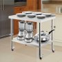 VEVOR stainless steel prep table with blenders, pots, and stacked plates in a kitchen.