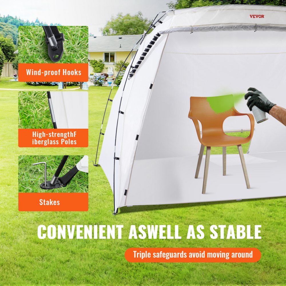 VEVOR portable paint booth with fiberglass poles and wind-proof hooks, spraying a chair in a yard.