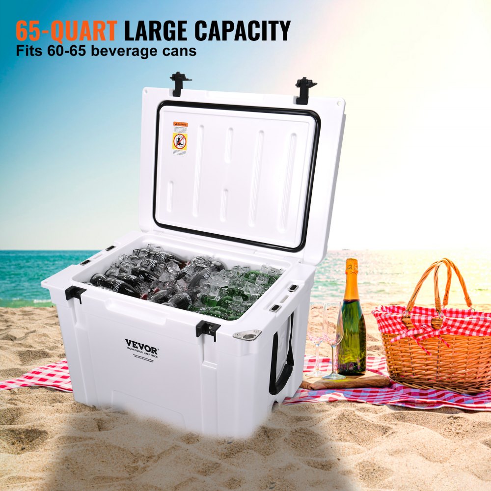 VEVOR portable cooler on sandy beach, filled with ice and beverage cans, next to picnic basket and bottles.