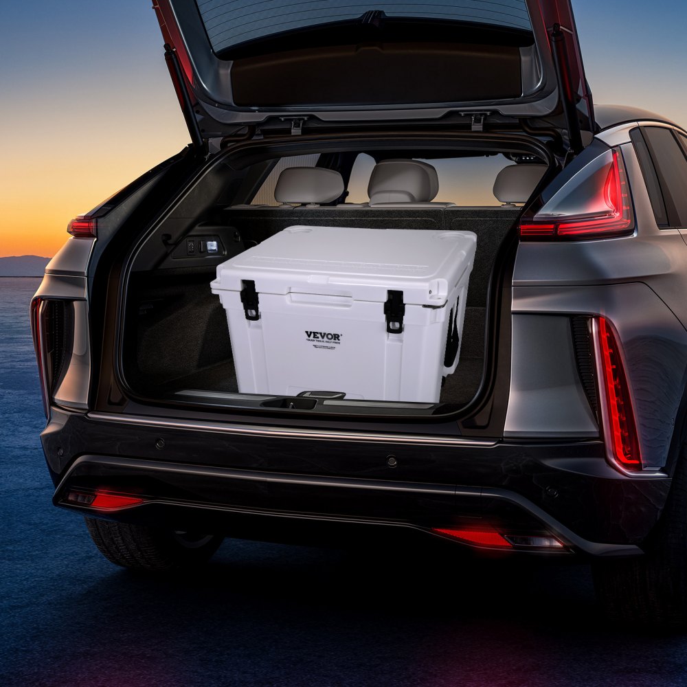 VEVOR portable cooler in the trunk of a car with taillights on at sunset.