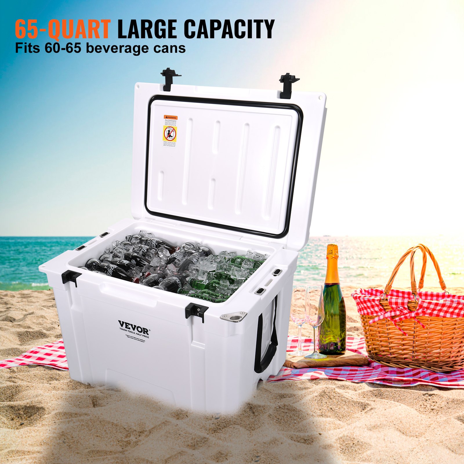 VEVOR portable cooler on sandy beach, filled with ice and beverage cans, next to picnic basket and bottles.