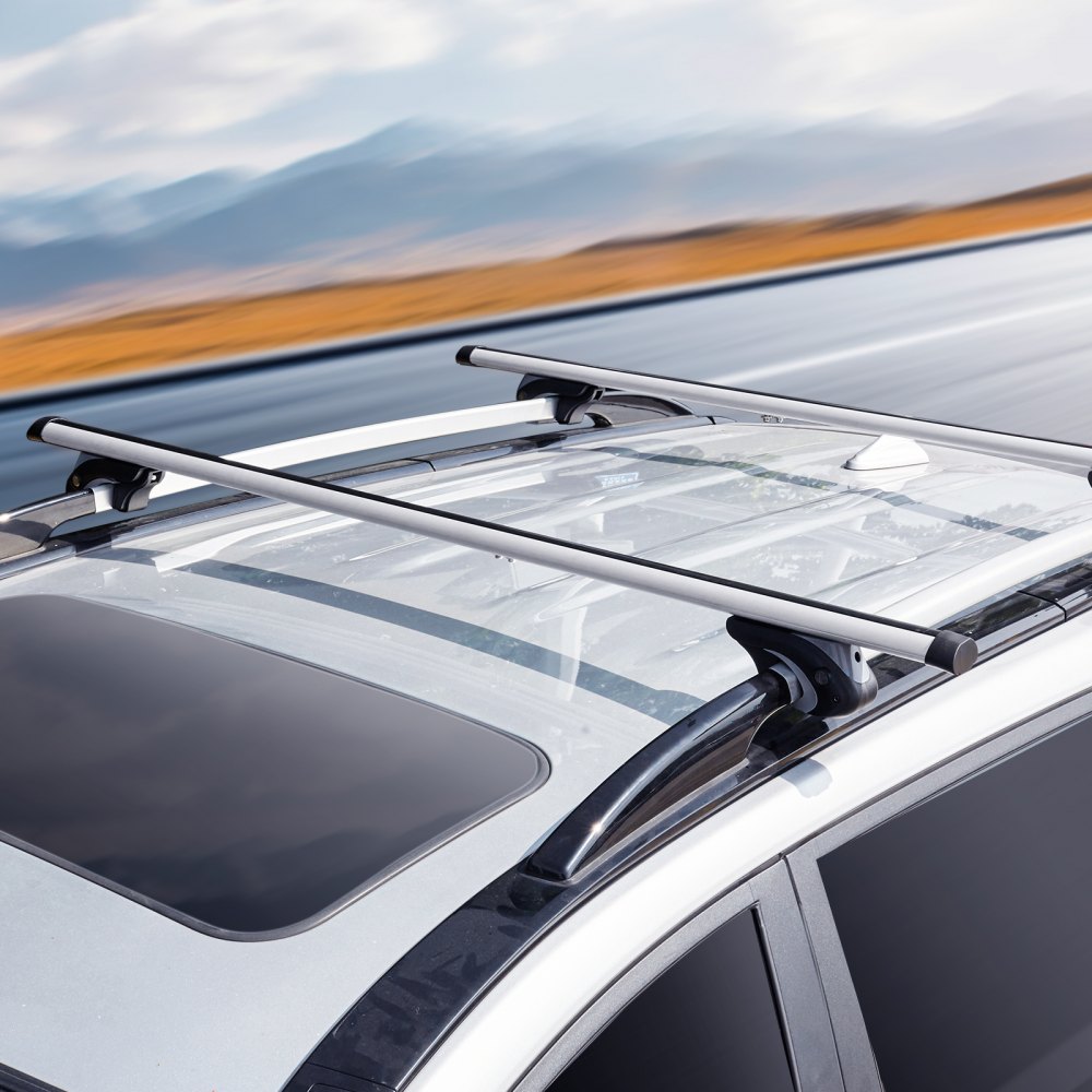 roof-mounted VEVOR roof rack cross bars on a moving car with a panoramic sunroof and mountainous background.