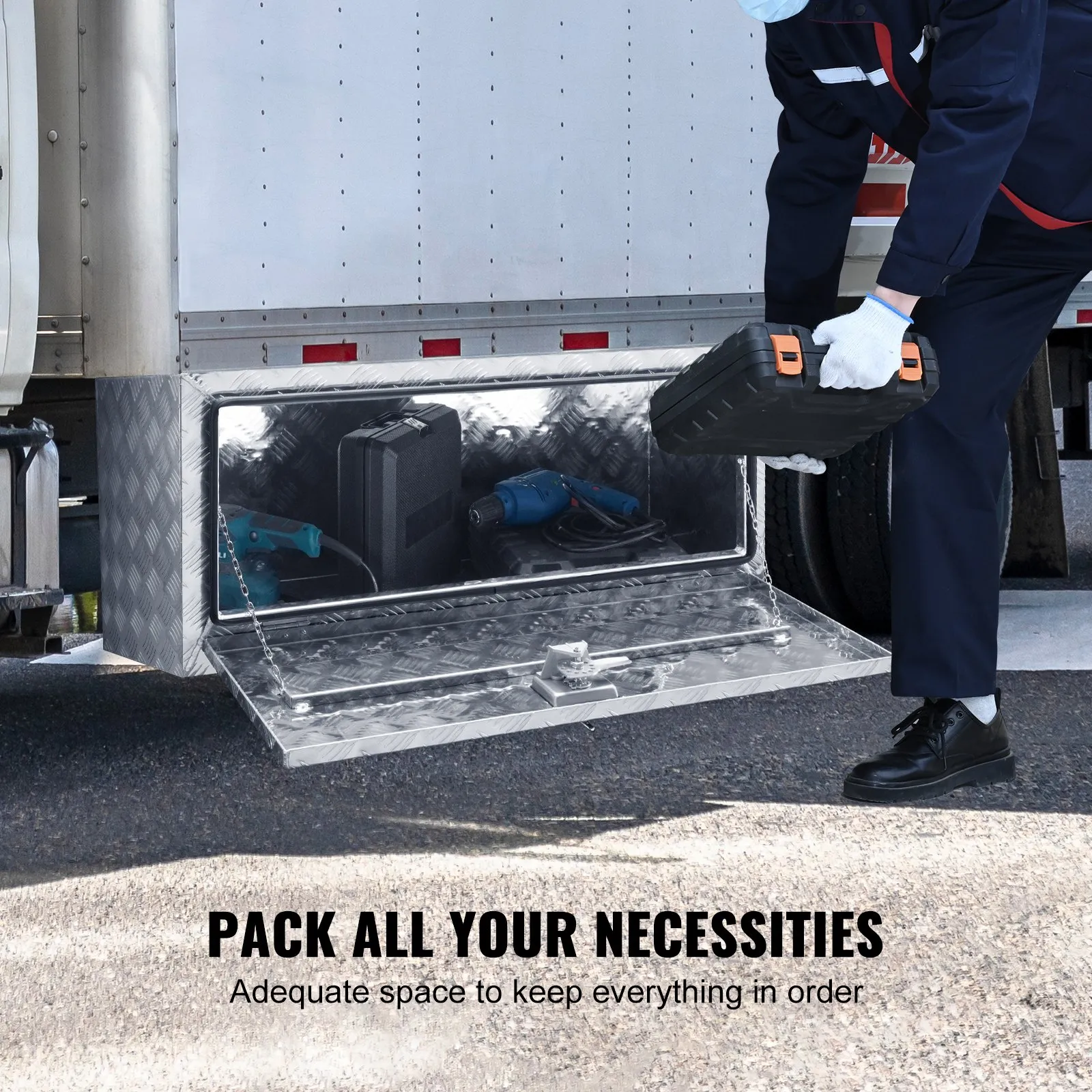 person organizing tools inside a VEVOR underbody truck box with large storage space under truck.