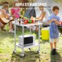 outdoor picnic scene featuring a VEVOR stainless steel work table with vegetables and a microwave.