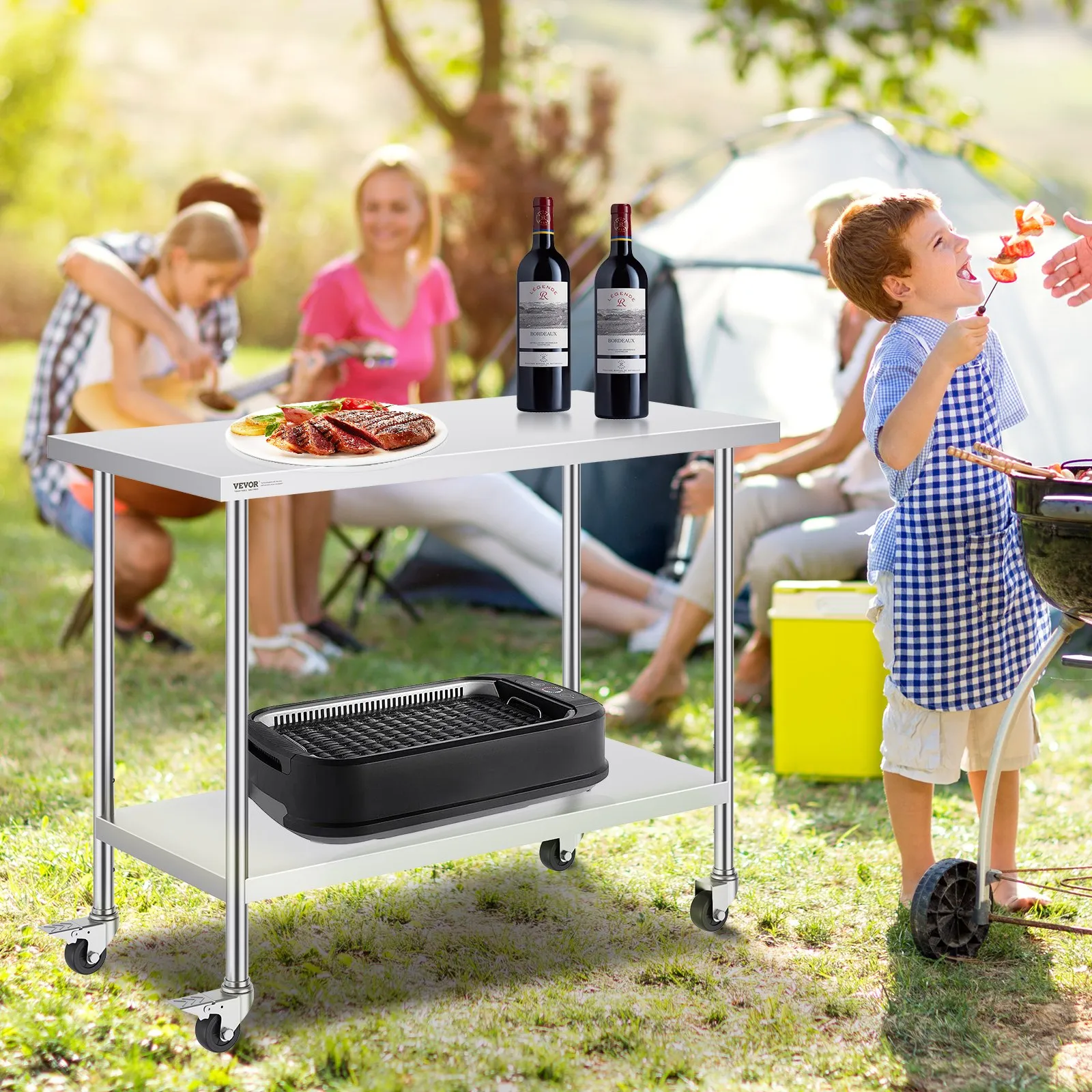 outdoor scene featuring a VEVOR stainless steel work table with wine bottles, food, and a grill in a park.