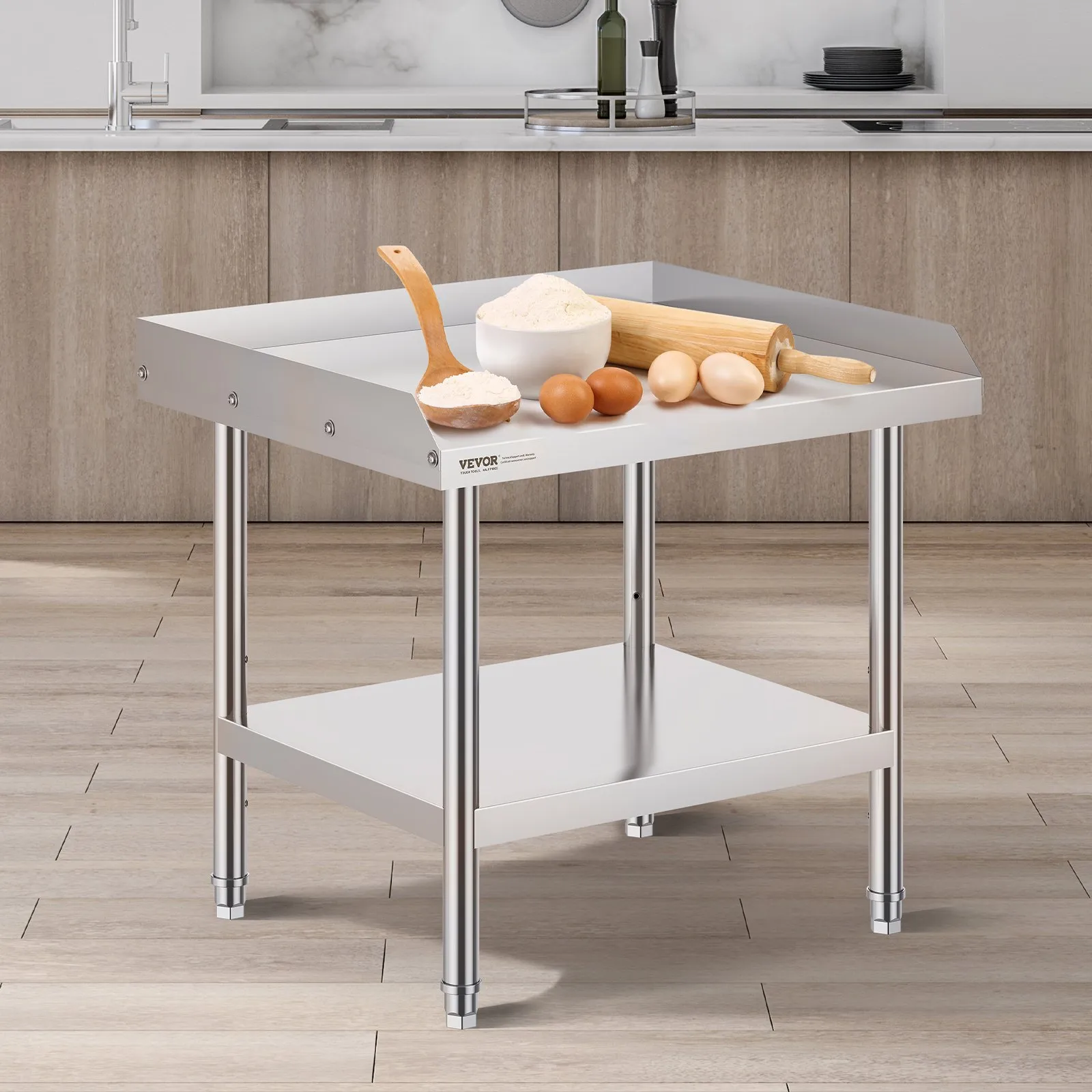 VEVOR stainless steel work table in kitchen, topped with flour, eggs, rolling pin, and utensils.