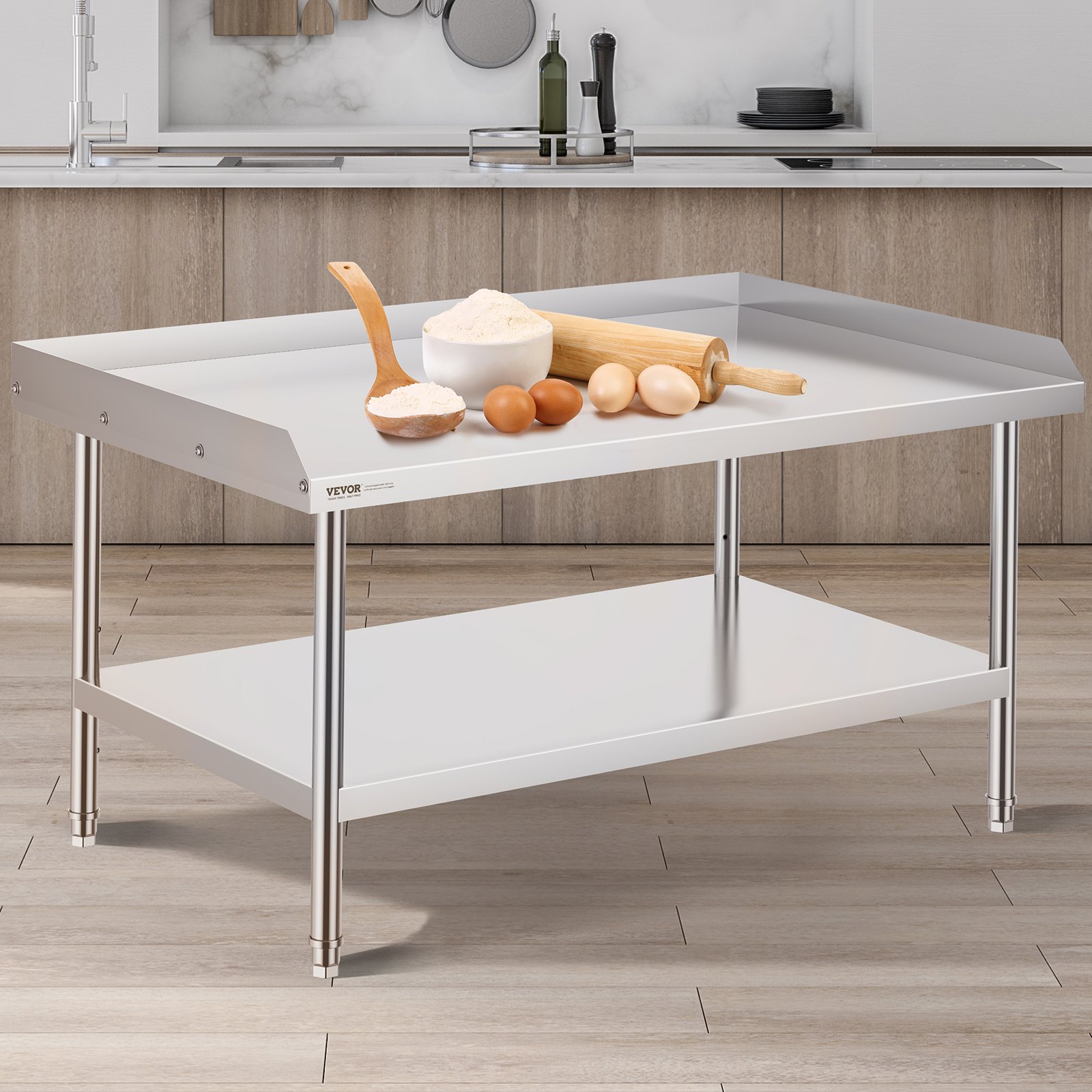 VEVOR stainless steel work table in a kitchen with baking tools and ingredients on top.