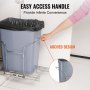 hand pulling out a VEVOR pull-out trash can with arched handle design in a kitchen cabinet.