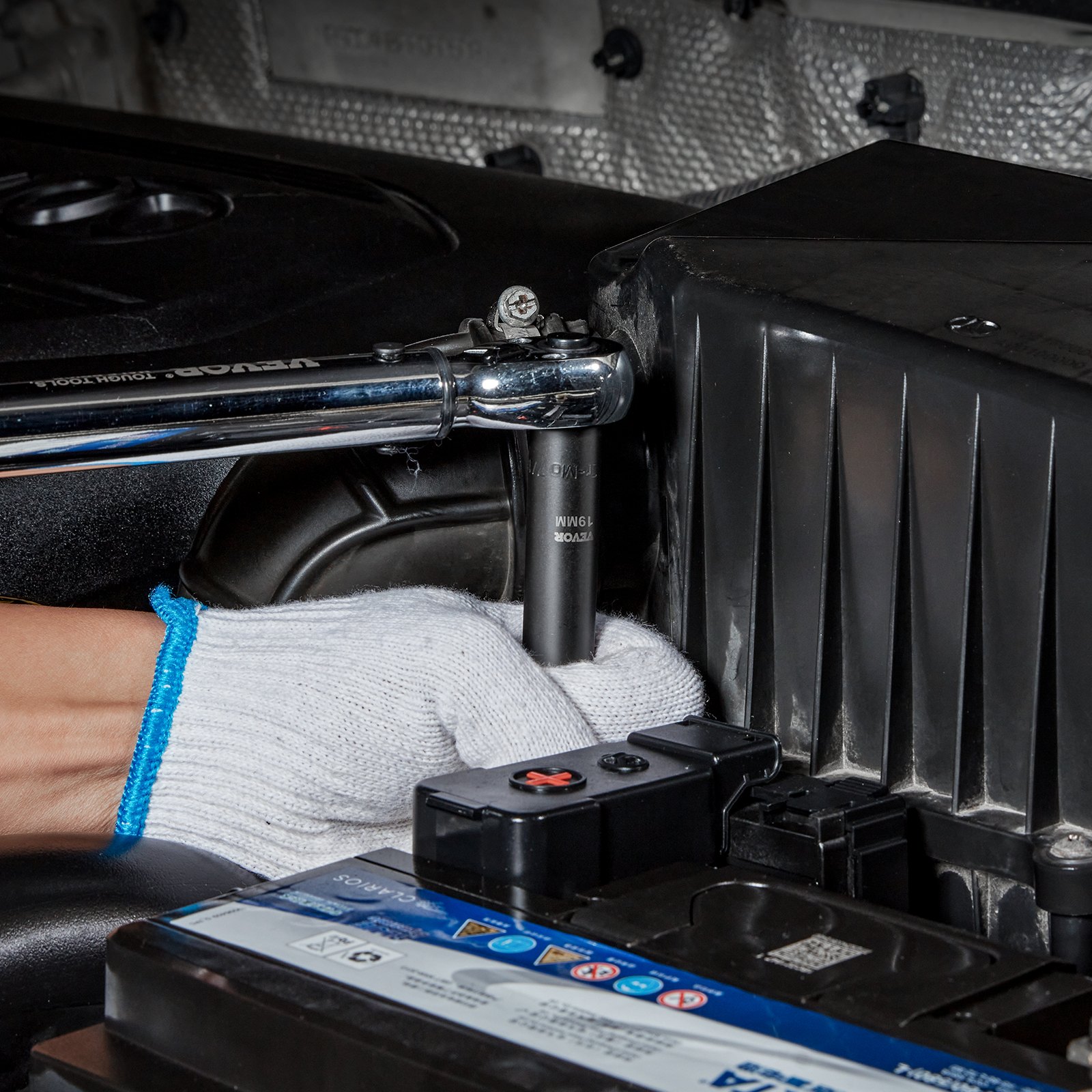 mechanic using a VEVOR impact socket set to work on an engine compartment.