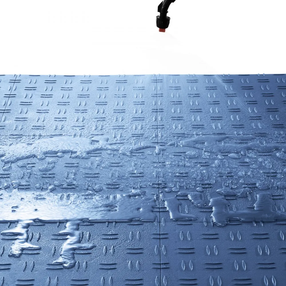 water spray cleaning VEVOR garage tiles with anti-slip surface, showing durability and water resistance.