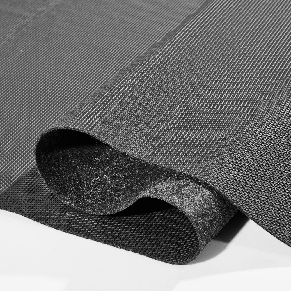 close-up of a textured black VEVOR garage floor mat partially rolled up, showcasing its material layers.