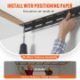 hand installing VEVOR overhead garage storage rack with drill and positioning paper, easy assembly.