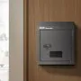 dark gray VEVOR door key drop box with combination lock mounted on a wooden wall panel.