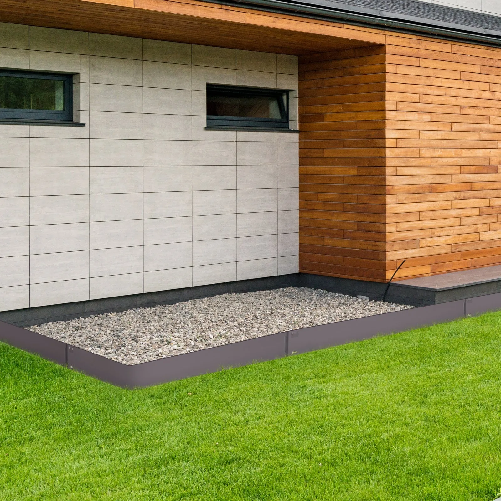 modern house facade with gray tiles and wooden panels, featuring VEVOR steel landscape edging around gravel.