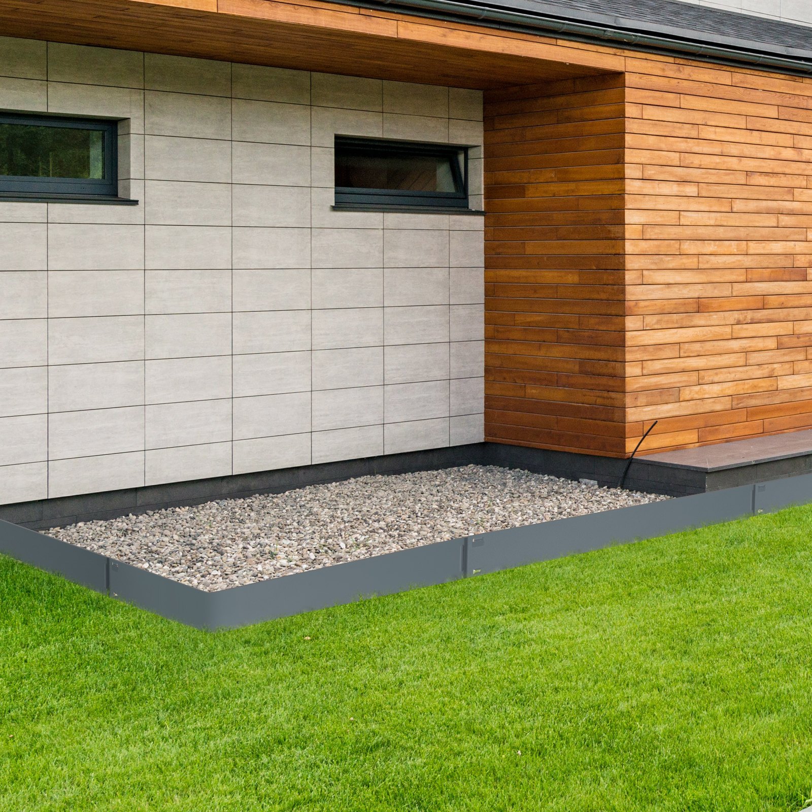 VEVOR steel landscape edging surrounding gravel area by modern wooden and tiled house exterior.