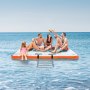 people relaxing on a VEVOR inflatable floating dock in the ocean, enjoying a sunny day.