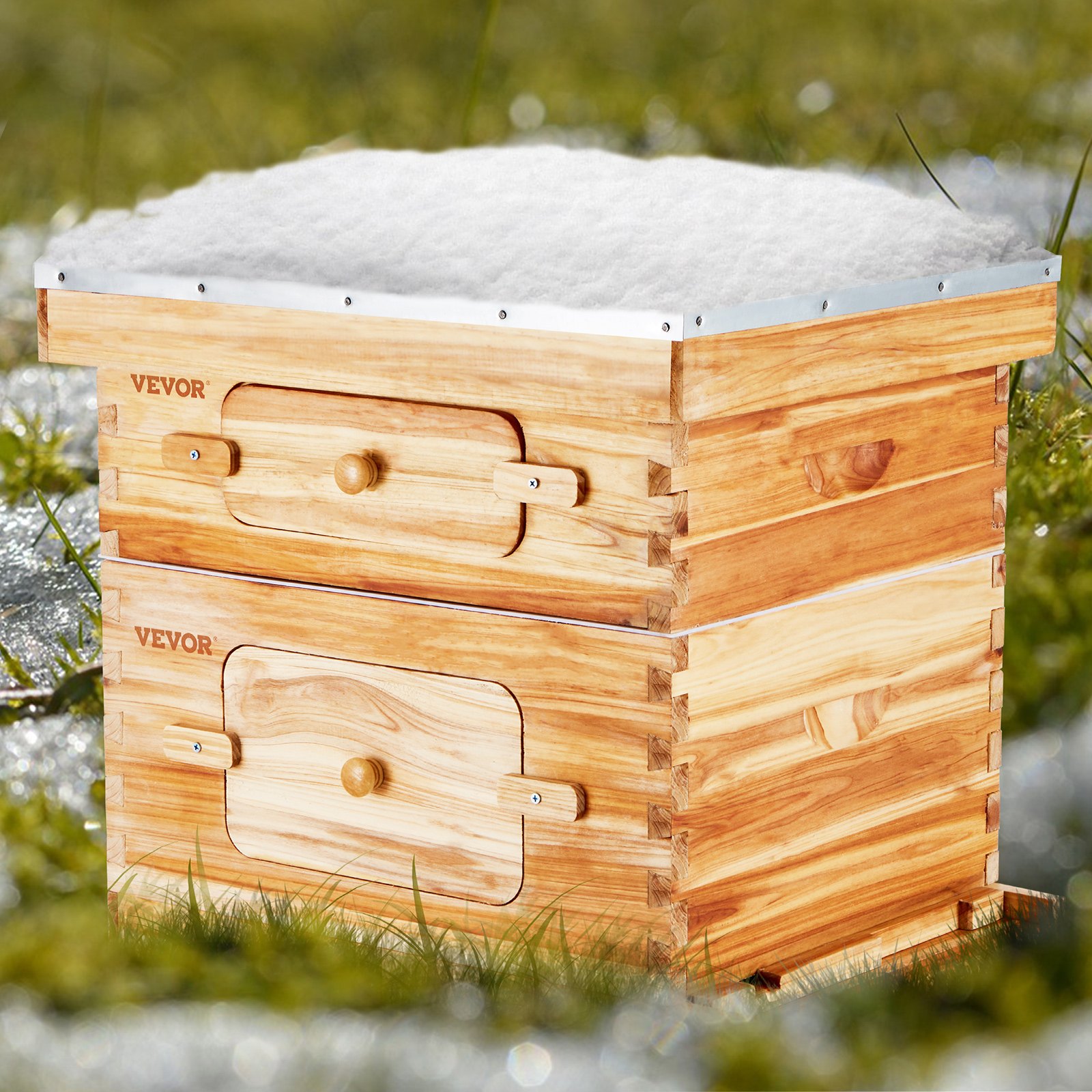 VEVOR bee hive starter kit in a grassy field, wooden structure with a snowy top.