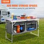 VEVOR camping table with storage, loaded with food and drinks, camper in the background.