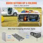 VEVOR camping table set up beside rv with storage compartments, beverages, and camping supplies.