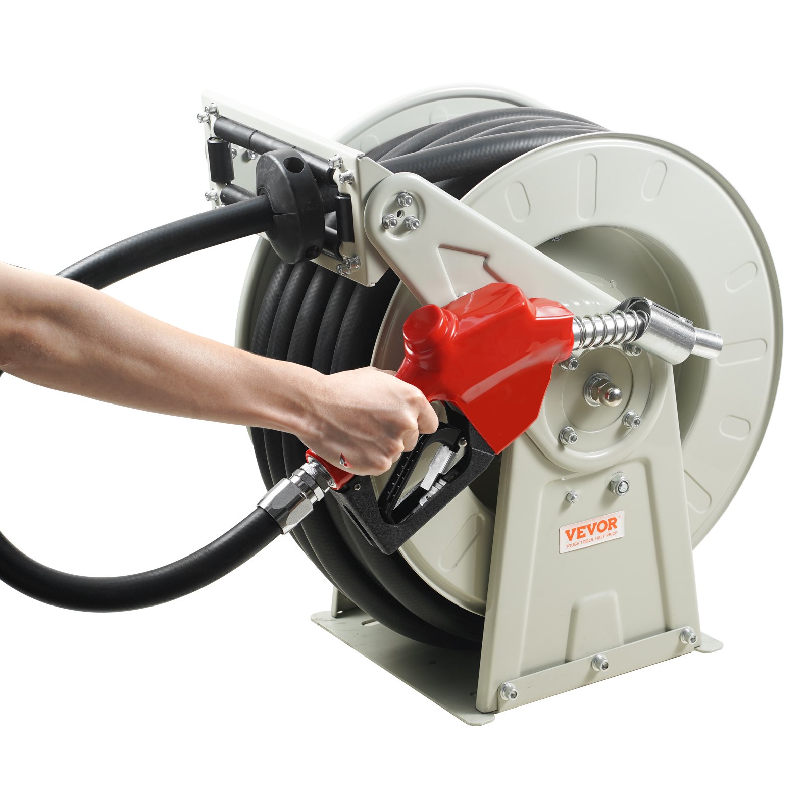 person holding a red fuel nozzle of a mounted VEVOR fuel hose reel.