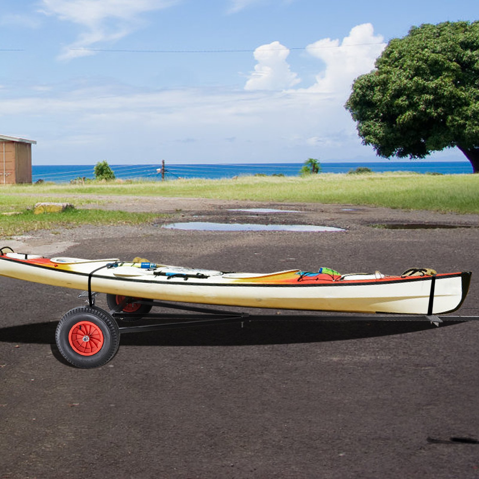 VEVOR boat trailer dolly with kayak on an asphalt ground near the ocean and green field.