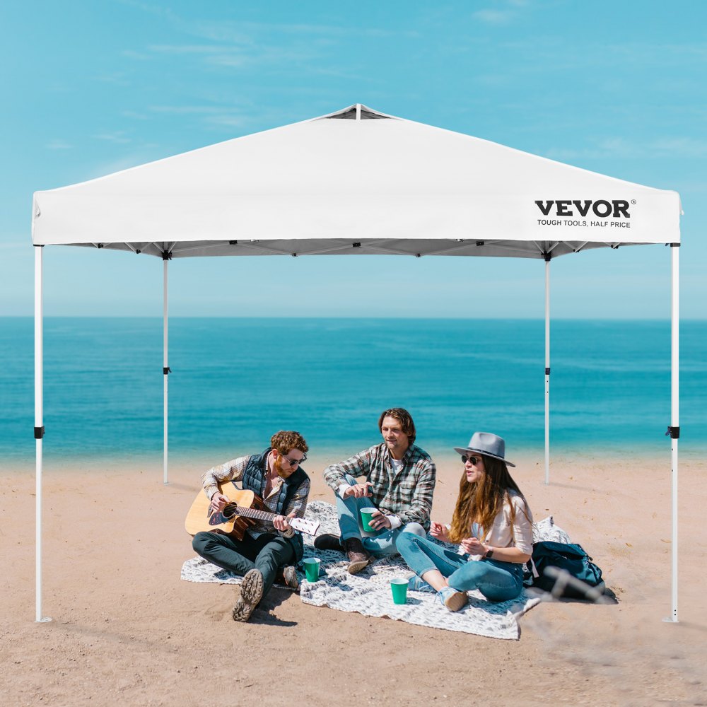 VEVOR pop up canopy tent on a beach with people sitting underneath, enjoying a sunny day by the sea.