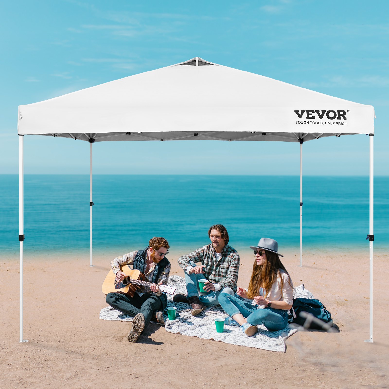VEVOR pop up canopy tent on a beach with people sitting underneath, enjoying a sunny day by the sea.