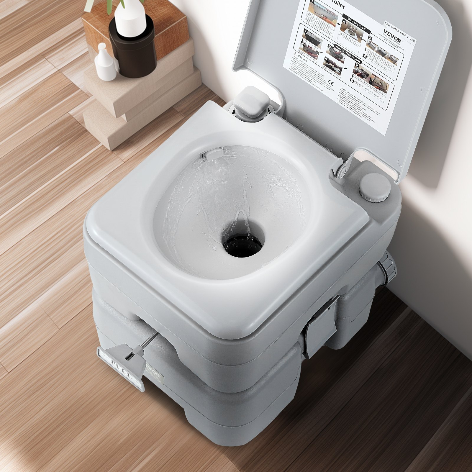 VEVOR portable toilet with flushing water on a wooden floor, open lid showing inside of toilet.