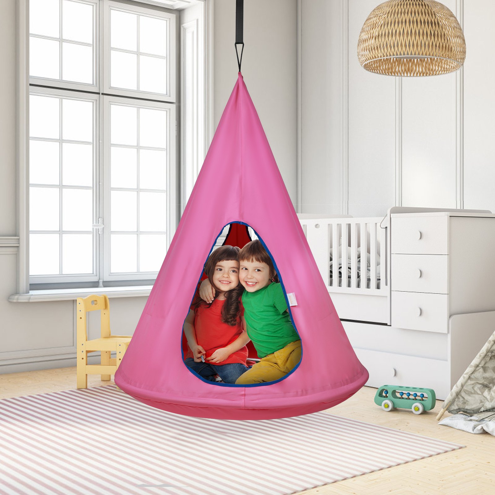 kids in colorful clothes in a pink VEVOR kids nest swing chair, hanging in a bright, modern nursery.