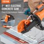 VEVOR electric concrete saw cutting stone, brick, and concrete with 2.5-inch slotting depth.