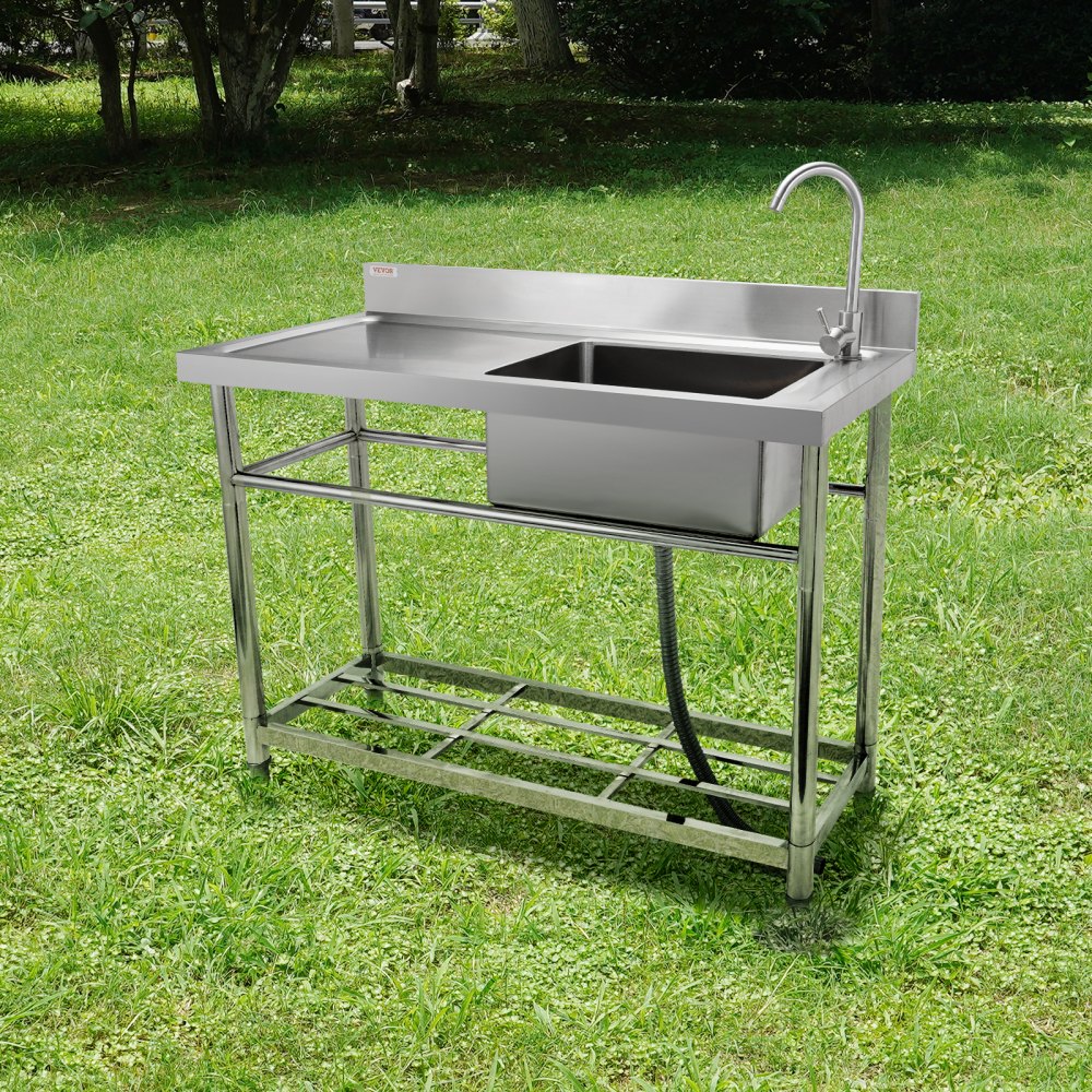 VEVOR commercial kitchen sink in a grassy outdoor area with stainless steel construction and faucet.