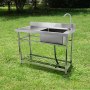 VEVOR commercial kitchen sink in a grassy outdoor area with stainless steel construction and faucet.