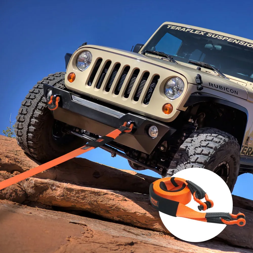 jeep being towed uphill using VEVOR heavy duty tow strap on rocky terrain under clear blue sky.