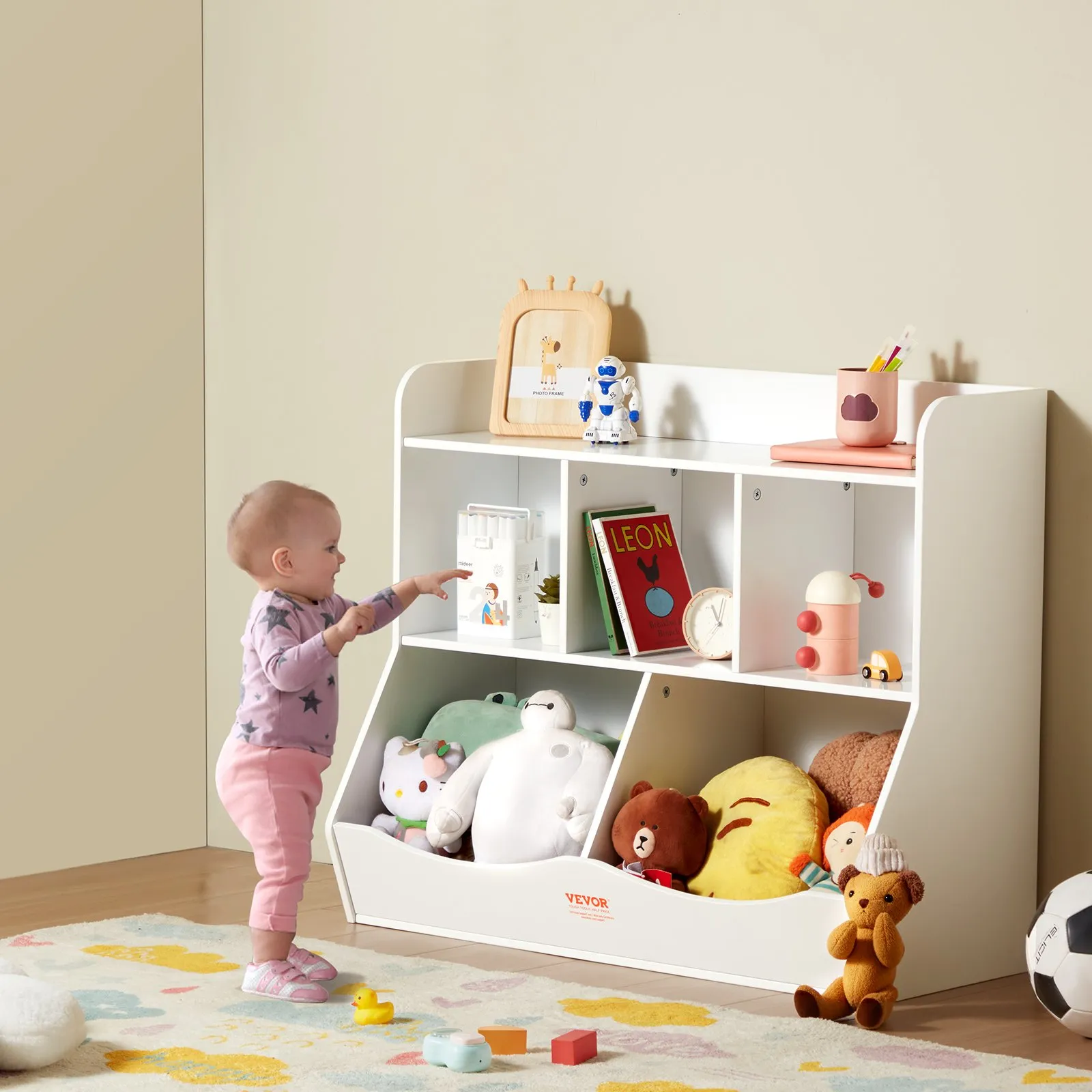 toddler reaches for toys on VEVOR toy storage organizer with books, stuffed animals, and playful decor.
