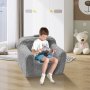 child reading on a cozy grey VEVOR kids armchair in a bright, playful room with a teddy bear in the background.