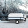 pontoon boat on a trailer covered by a VEVOR pontoon boat cover in a snowy forest background.