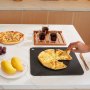 VEVOR pizza steel showcasing two pizzas, drinks, a plate of mangoes, and grapes on a white countertop.