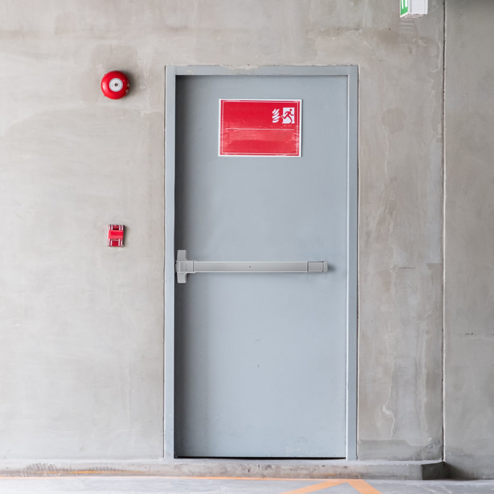 emergency exit with VEVOR push bar door lock, red fire alarm, and exit sign on concrete wall.
