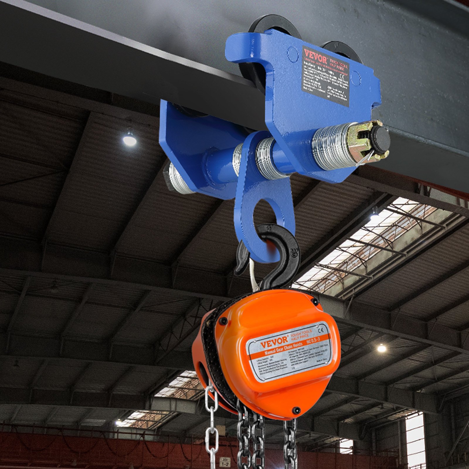 VEVOR manual trolley with orange hoist attached to beam in industrial setting.