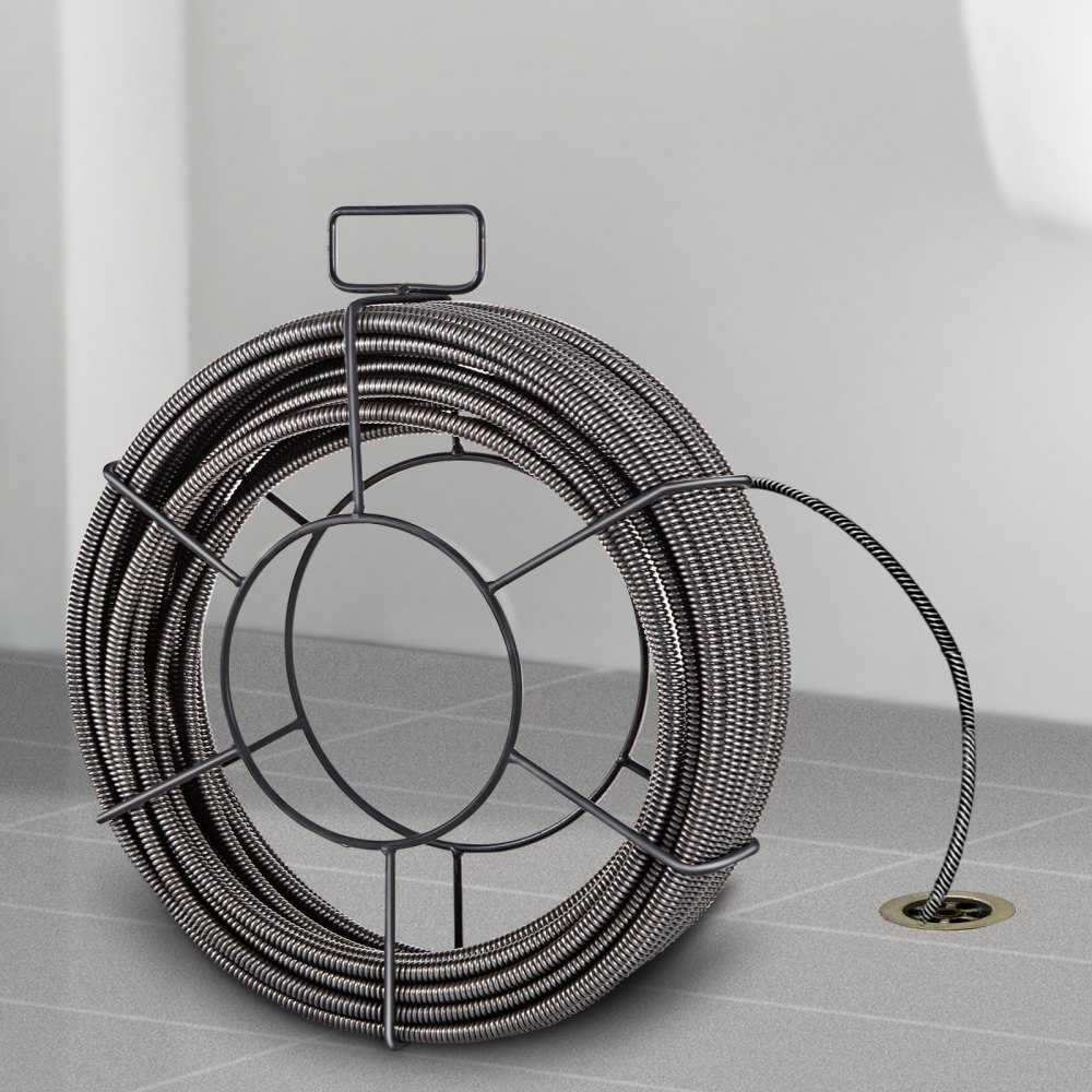 VEVOR drain cleaning cable coiled on the floor with its end inserted in a drain.