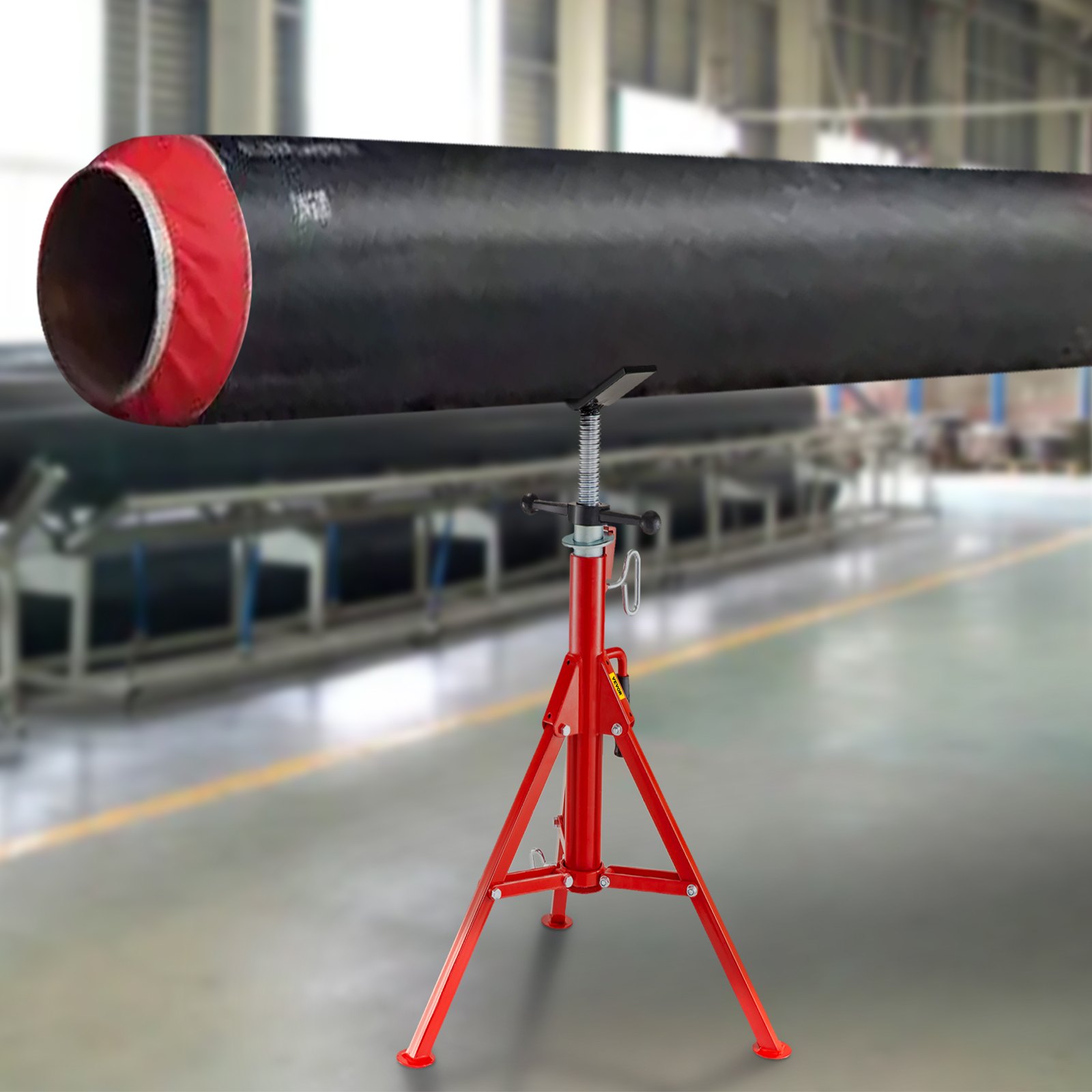 VEVOR pipe stand holding a large, black pipe on a red tripod in an industrial setting.