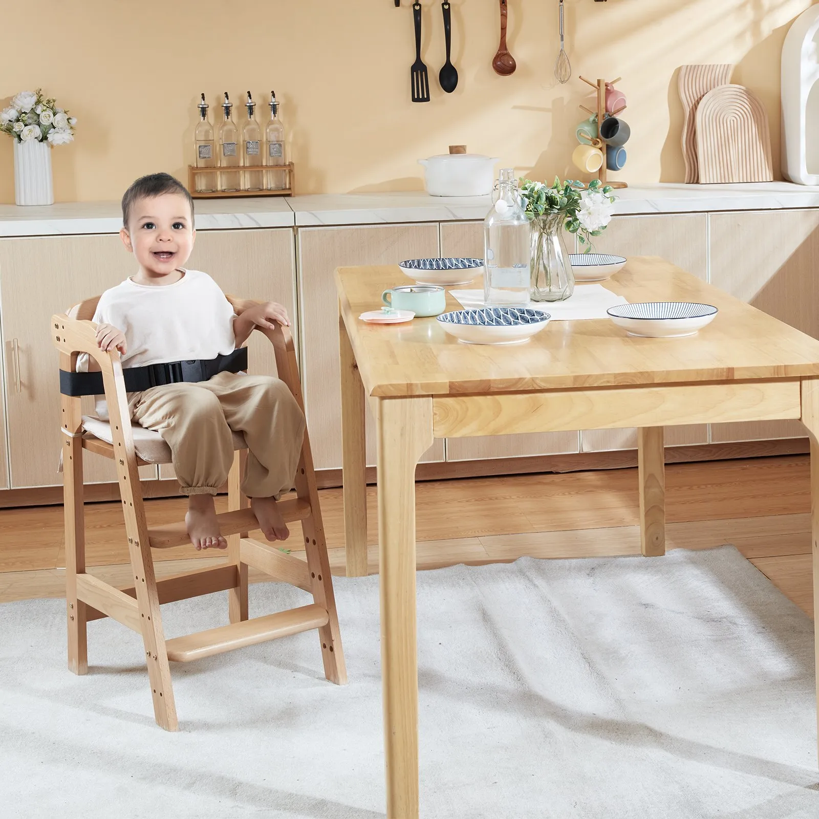 child sitting in VEVOR wooden high chair at a dining table with tableware and flowers in a modern kitchen.