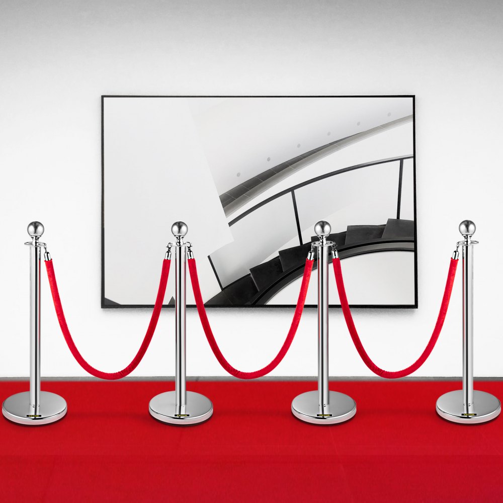 VEVOR stanchion posts with red ropes on a red carpet in front of a framed staircase art.